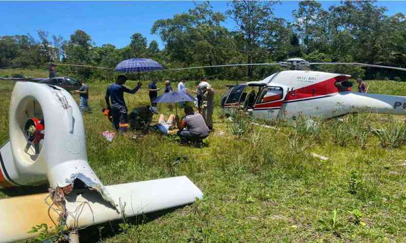 Passageiro recebe atendimento dos bombeiros no local do acidente com aeronave danificada 