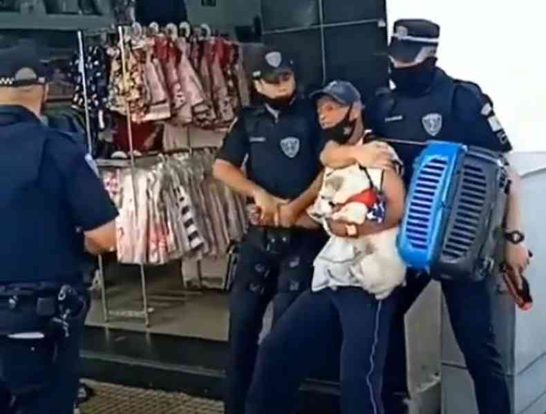Momento em que Jadir, com sua cachorrinha no colo,  abordado pelos guardas(foto: Reproduo)