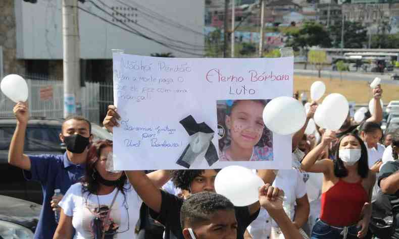 Pessoas se manifestaram com gritos de justia no velrio da menina Brbara Vitria. Uma delas segura um cartaz. 