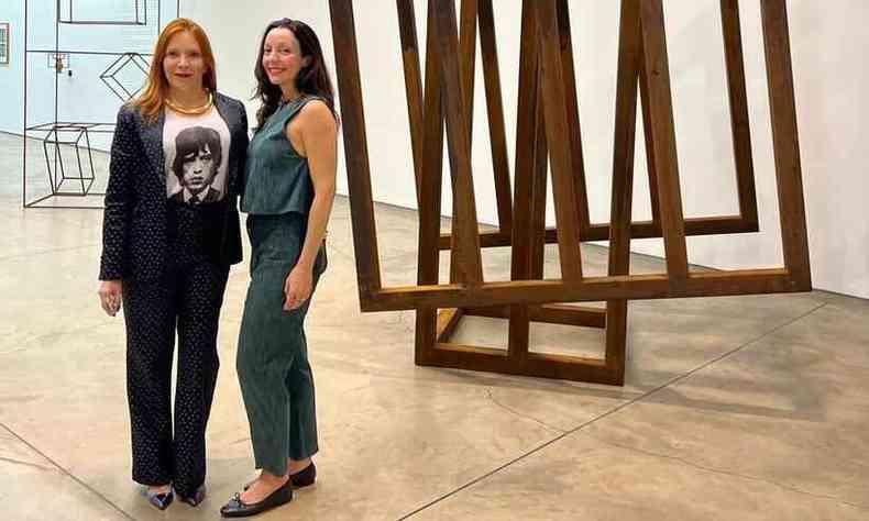 Flvia Albuquerque e Marina Conde ao lado de escultura do artista Raul Mouro 