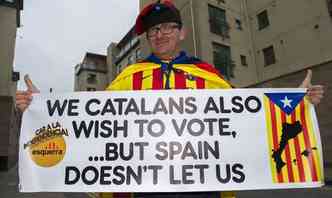 'Ns catales tambm queremos votar, mas a Espanha no nos deixa', diz o cartaz levado em apoio  independncia escocesa(foto: LESLEY MARTIN / AFP)