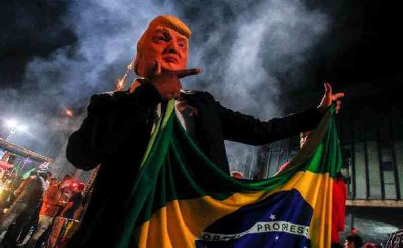 Apoiador de Bolsonaro festeja vitria usando mscara de Trump em So Paulo(foto: Miguel Schincariol/AFP)