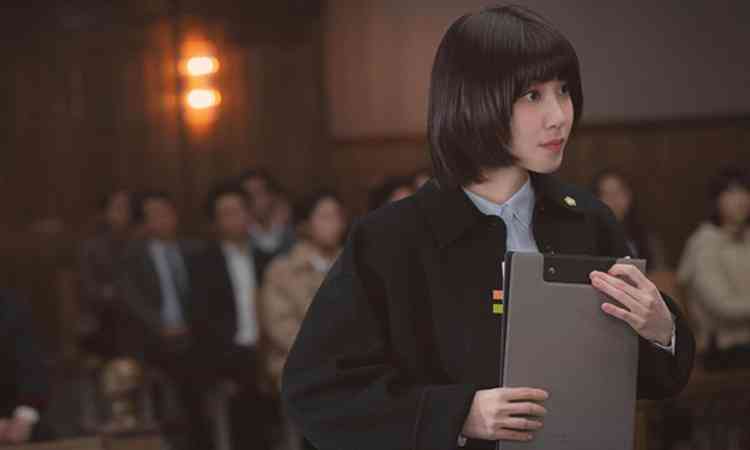 Atriz Park Eun-bin, que interpreta advogada advogada do espectro autista, segura papis no tribunal