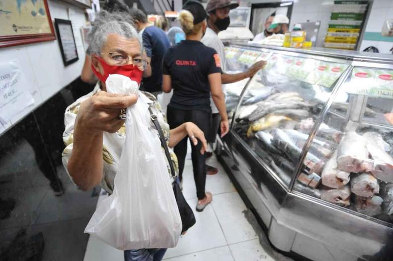 Sandra Maria mostra o embrulho com o peixe cao