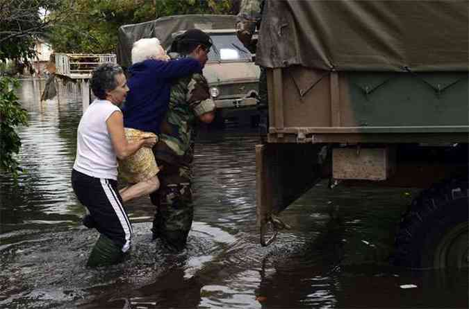 Vrias pessoas, inclusive idosos, tiveram de ser retirados de suas casas devido  inundao(foto: AFP PHOTO / DANIEL GARCIA )