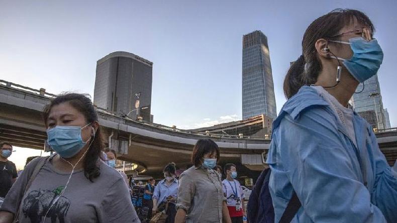 (foto: Getty Images) Trabalhadores em Pequim