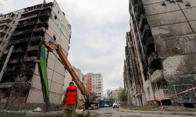 Homem observa prdios parcialmente queimados e destrudos por bombardeios