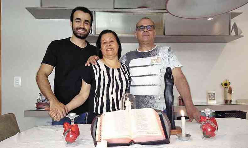 Com o filho Thiago, Adail Martins e Iris rezam com a bblia  mesa(foto: Arcevo pessoal)