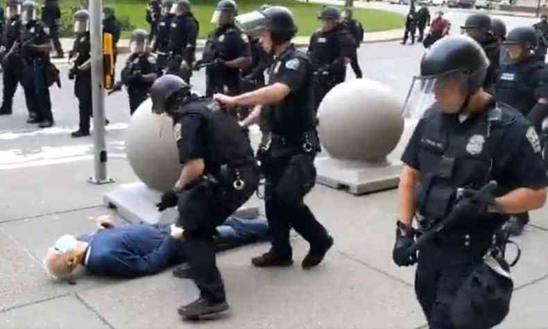 Dois policiais so vistos empurrando o manifestante, cuja cabea bate no cho com fora(foto: MIKE DESMOND / WBFO NPR / AFP)