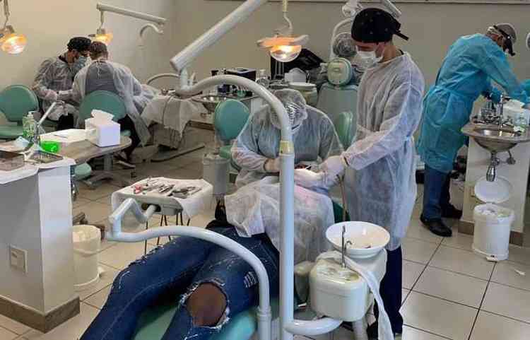 dentistas atendendo uma pessoa que est deitado em uma cadeira 