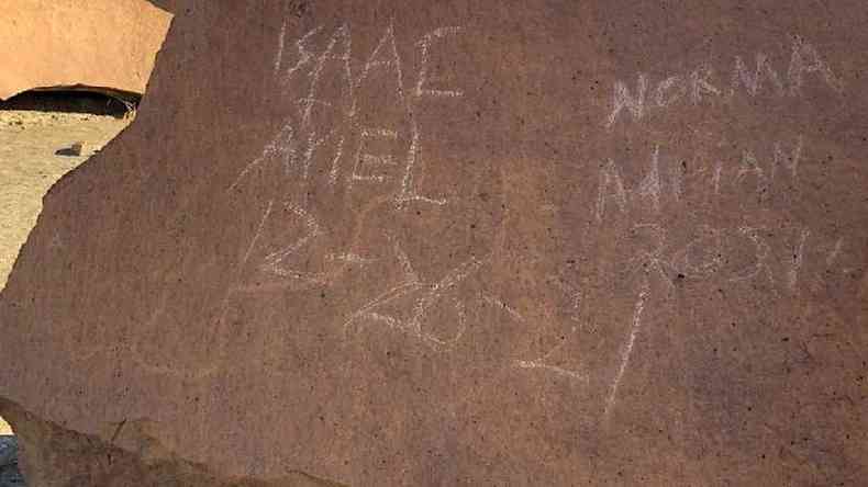 Names scratched over rock panel in Texas