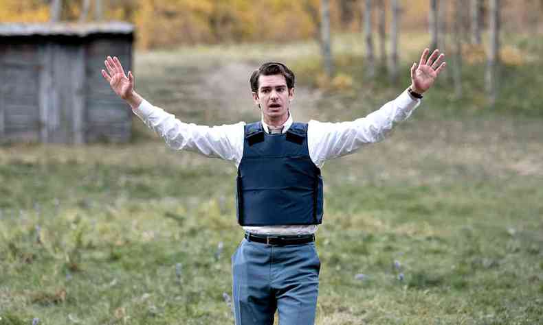 O ator Andrew Garfield abre os braos em paisagem rural vestido como o personagem Jeb Pyre na srie em nome do cu