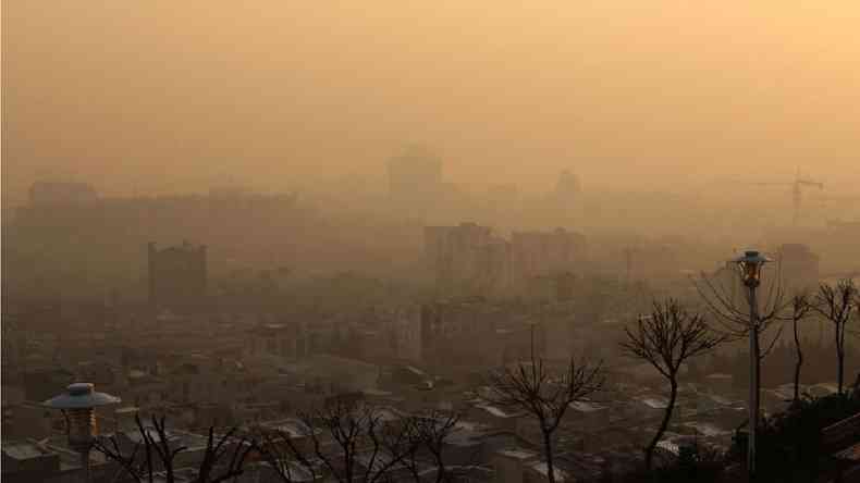 O sol se pe sobre a capital iraniana, Teer, enquanto altos nveis de poluio do ar cobrem a cidade em 13 de janeiro de 2021(foto: ATTA KENARE/AFP via Getty Images)