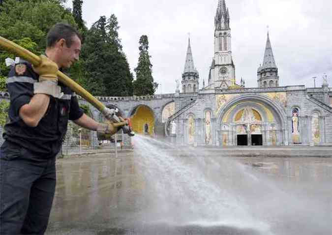 Bombeiro trabalha na operao de limpeza do santurio(foto: AFP PHOTO/PASCAL PAVANI )
