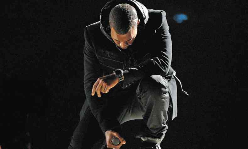 Kanye West canta ajoelhado, com o rosto abaixado, durante a cerimnia do Grammy em 2008, nos Estados Unidos