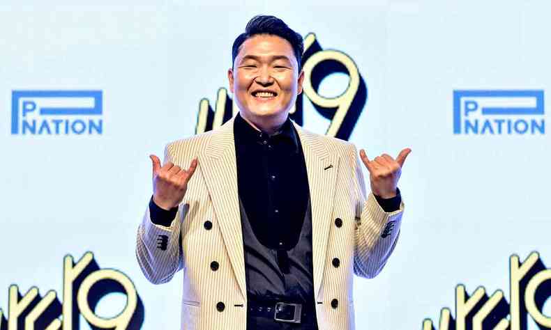 Cantor sul-coreano Psy sorri, fazendo gestos de positivo com os dedos, na entrevista de lanamento de seu nono disco durante evento em Seul