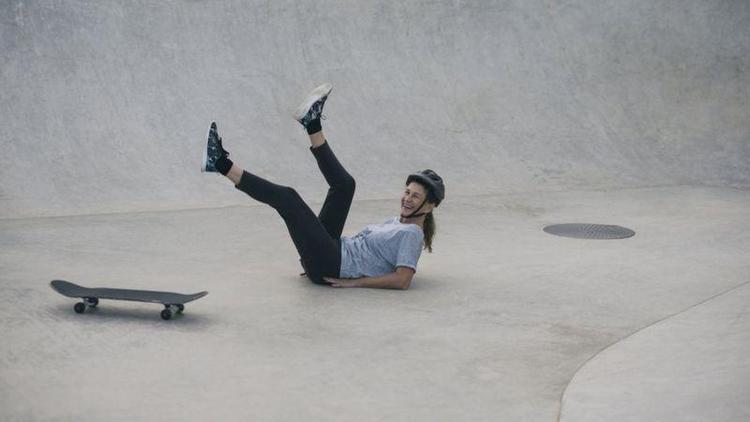 Mulher sorrindo aps cair de skate