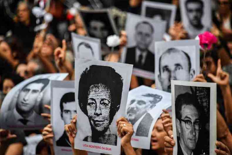 Manifestantes erguem fotos de pessoas mortas ou desaparecidas durante a ditadura de 1964-1985, em So Paulo, em 31 de maro de 2019