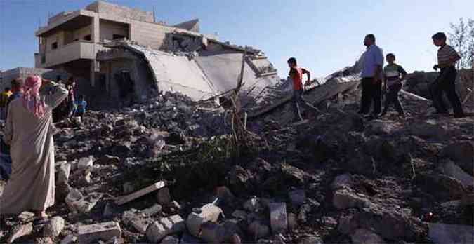 Moradores observam casas destrudas no distrito de Azaz, na Sria.(foto: REUTERS/Zain)