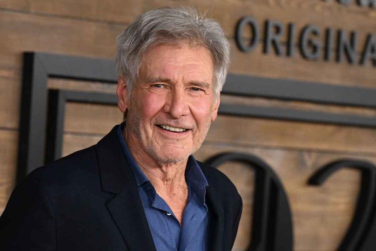 Harrison Ford posa para foto, de camisa azul e palet preto, na premire de '1923', em Los Angeles