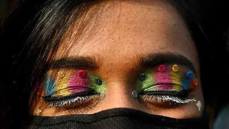 Olhos com sombra de glitter nas cores do arco-ris de ativista dos direitos de gnero da comunidade LGBTQ na parada do orgulho gay de Nova Dli