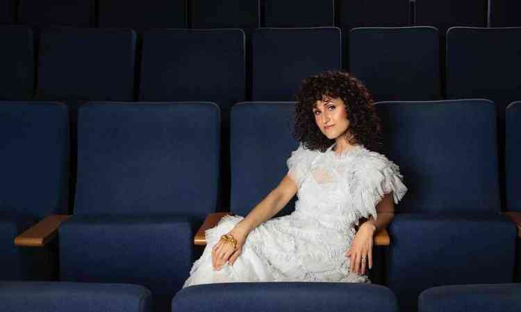  cantora e compositora Maria Mendes, sentada em sofá, olha para a câmera
