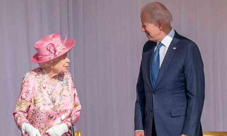 Rainha Elizabeth II de rosa a esquerda e Joe Biden de terno a direita