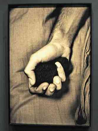 Retrato da mão de um homem segurando uma bola de pano 