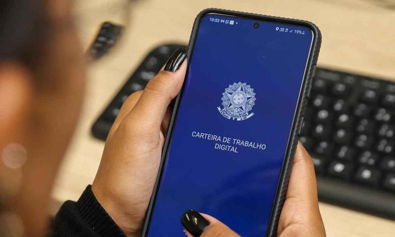 Do total de oportunidades, 318 delas estão destinadas a pessoas com deficiência(foto: Gil Leonardi/Imprensa MG) Imagem de uma pessoa segurando um telefone com o aplicativo da carteira de trabalho