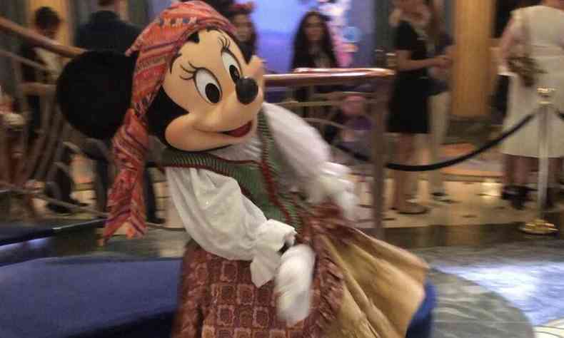 A person dressed as Minnie on a cruise where passengers travel with Disney characters