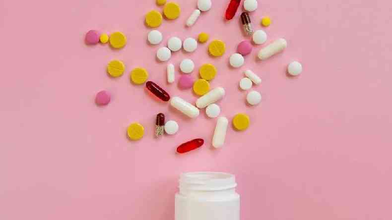 Comprimidos e cpsulas num fundo rosa