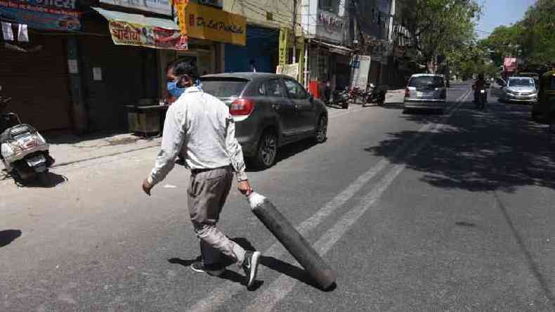 Homem carrega cilindro vazio de oxignio; item chega a custar dez vezes mais no mercado ilegal(foto: Getty Images)