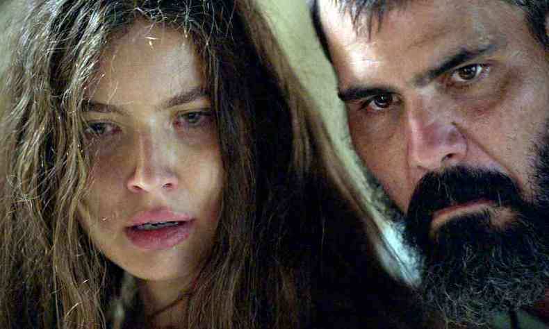 Atores Alanis Guillen e Juliano Cazarré, com os rostos tensos, em cena da novela Pantanal