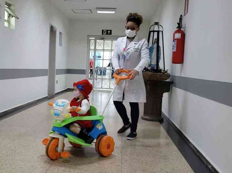 A pequena Sofia Parola, de 3 anos, brinca nos corredores do hospital como se estivesse em casa. A enfermeira Raquel de Souza  a sua sempre companheira(foto: Santa Casa BH/Divulgao)