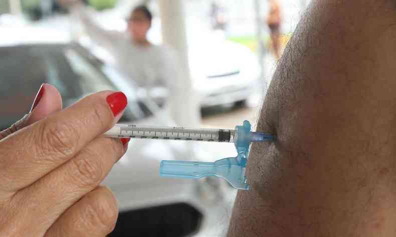 Enfermeira com seringa contendo a vacina Pfizer