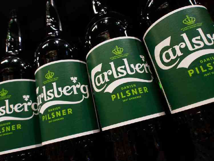 Bouteilles de bière Carlsberg sur l'étagère du supermarché