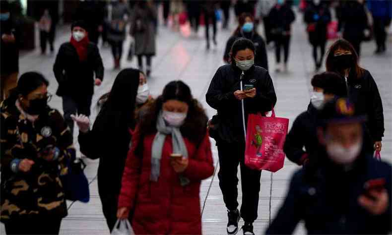 Populao usa mscaras protetoras em uma rua de Xangai, nesta quarta-feira (foto: NOEL CELIS/AFP)