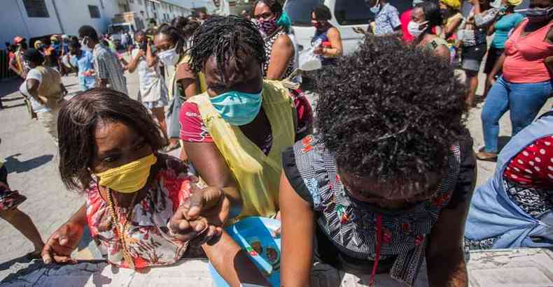 Crianas e adultos brigam por alimentos na capital Porto Prncipe, onde as atividades econmicas esto limitadas(foto: Pierre Michel Jean/AFP)