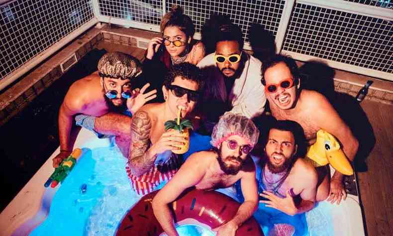 Sem camisa, com culos escuros, touca na cabea e drinks, integrantes da Lamparina so fotografados numa banheira