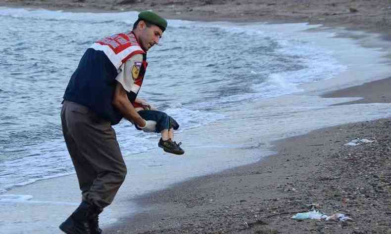 A fotografia de um agente turco carregando o menino foi difundida por meios de comunicao e pelas redes sociais com a hashtag #KiyiyaVuraninsanlik (A humanidade  um fracasso, em turco)(foto: AFP PHOTO / DOGAN NEWS AGENCY )