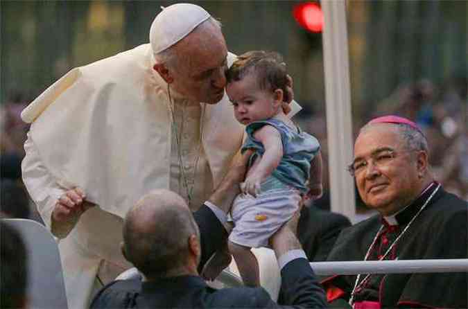 Seguido por milhares de fiis, o papa Francisco beijou ao menos cinco crianas no trajeto entre o aeroporto do Galeo e a Catedral Metropolitana do Rio de Janeiro(foto: REUTERS/Raphael Lima)