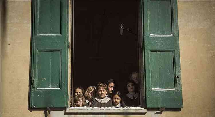 Cena do filme 'Le pupille' tem meninas debruadas sobre janela verde