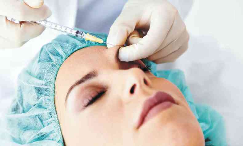 Mulher recebe aplicação de botox, realizada por meio de agulha 