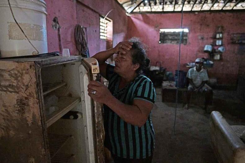 Maria da Silva chora ao mostrar geladeira vazia em casa(foto: CARL DE SOUZA / AFP) Maria da Silva chora ao mostrar geladeira vazia em casa