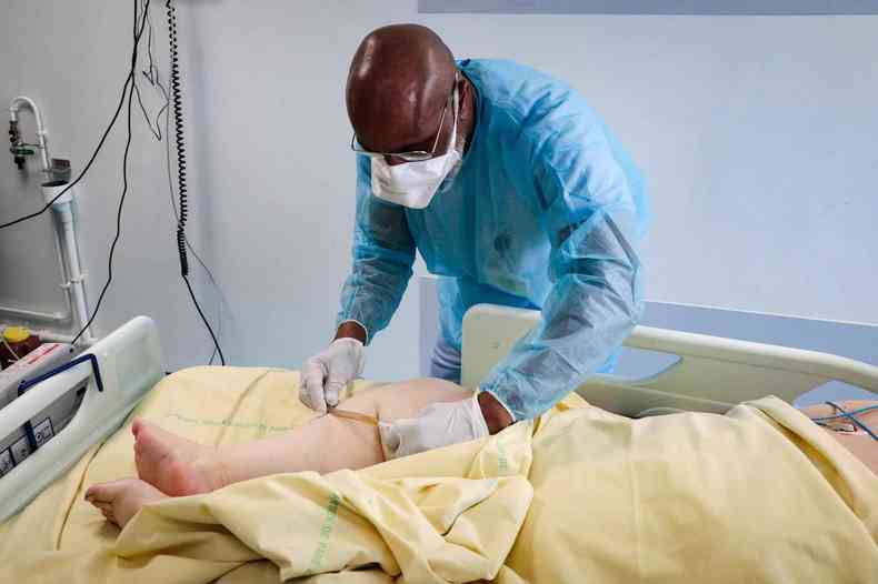 Enfermeiro atende paciente com COVID