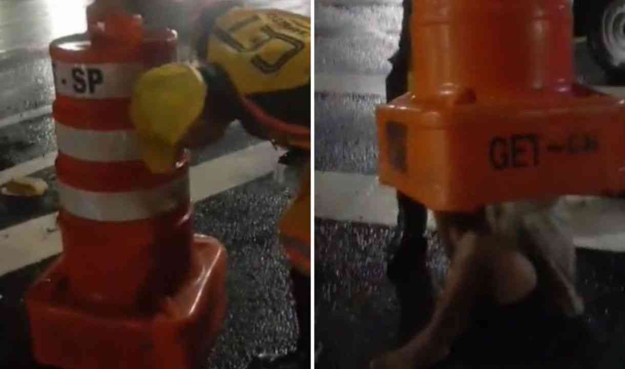  Vídeo: Homem se esconde da chuva dentro de cone de trânsito e fica entalado 