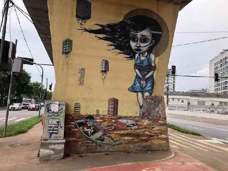 Grafite de uma criança amarrada em pilastra do viaduto