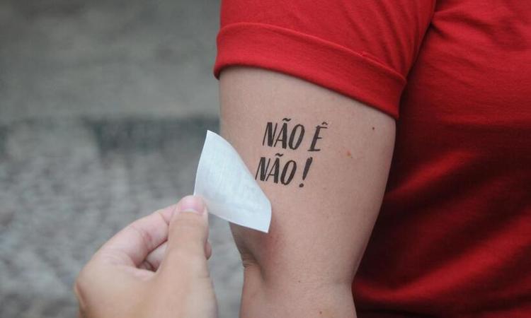 mulher aplica adesivo no brao: no  no