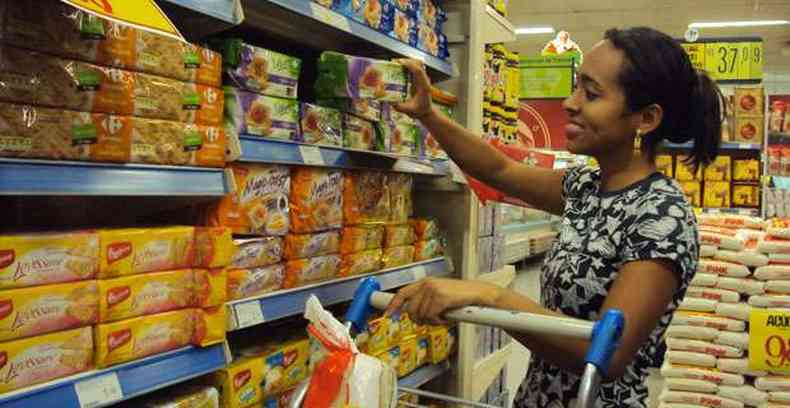 Joseane escolhe os produtos para a patroa nas prateleiras do supermercado(foto: Daniela Rezende)