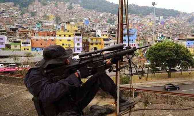 Policial faz segurana na rea onde ocorreu solenidade de inaugurao da UPP da comunidade de 70 mil habitantes (foto: ANTNIO SCORZA/AFP)